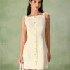 The Beige Boat Neck Button Mini Dress